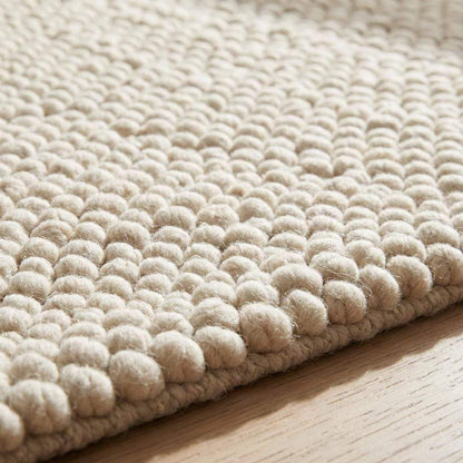 Handwoven chunky wool pebble rug in cream with textured pebble design for Scandinavian minimalist home decor