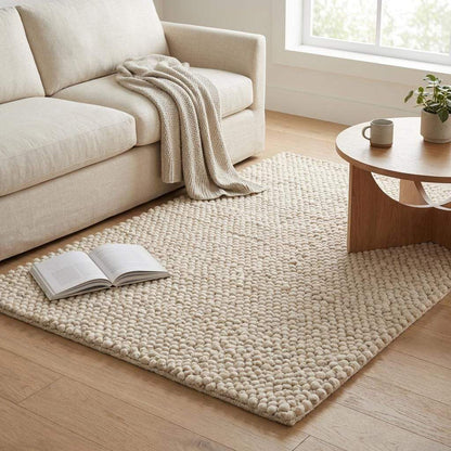 Handwoven chunky wool pebble rug in cream with textured pebble design for minimalist Scandinavian home decor