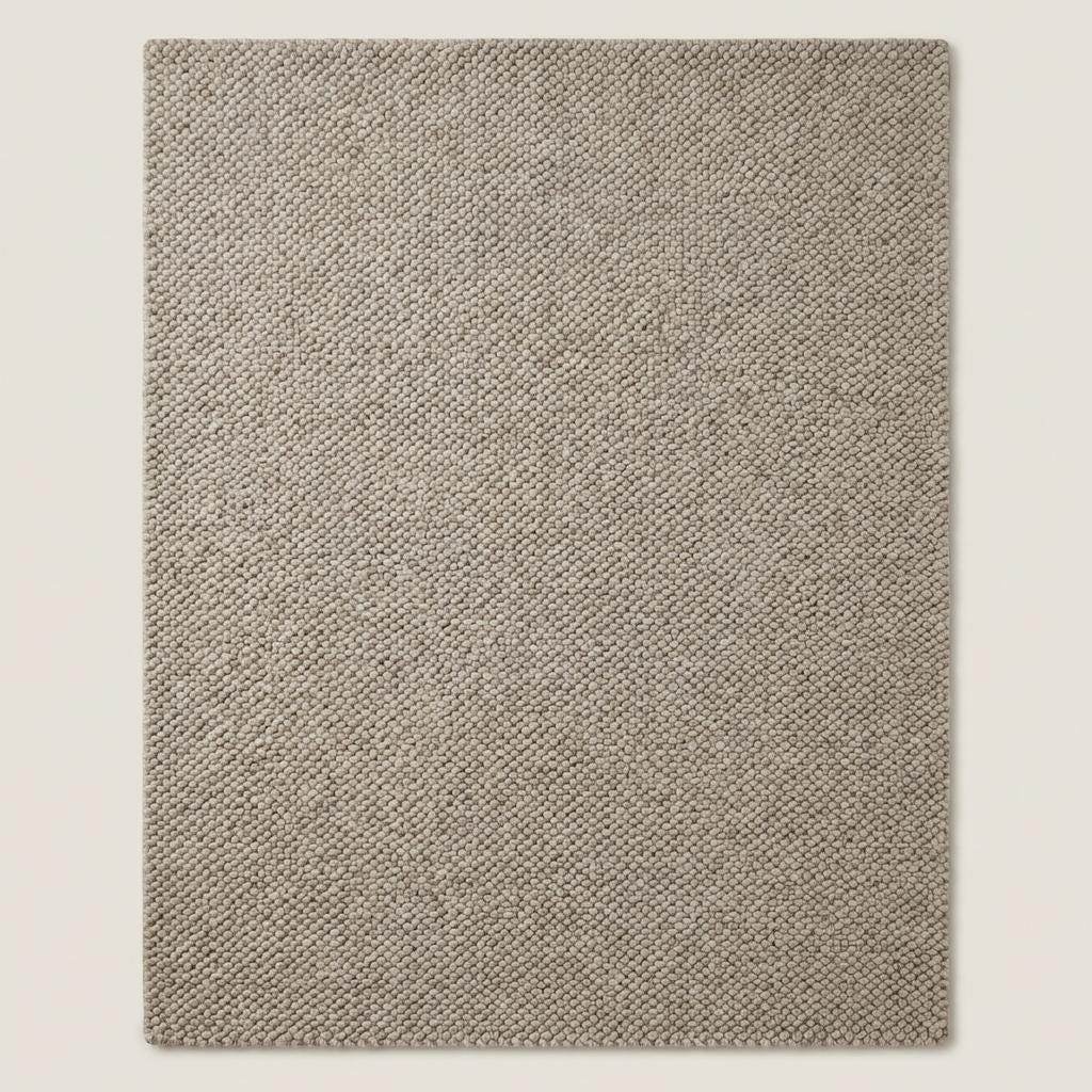 Chunky wool rug in neutral beige with thick loop weave for cozy minimalist Scandinavian decor