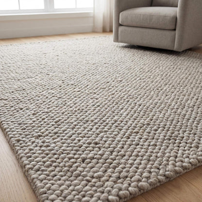Chunky wool rug in neutral beige with thick loop weave for minimalist Scandinavian decor