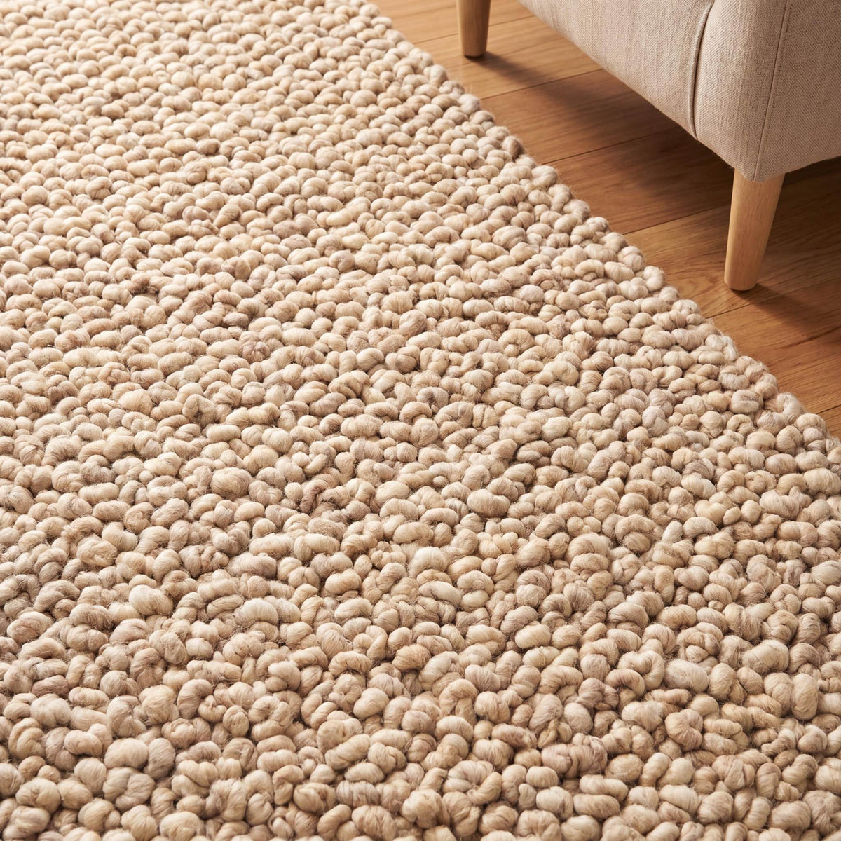 Chunky wool rug with thick loop pile in neutral beige, handwoven textured area rug for minimalist living room