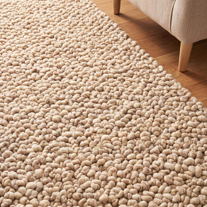 Chunky wool rug with thick loop pile in neutral beige, handwoven textured area rug for minimalist living room