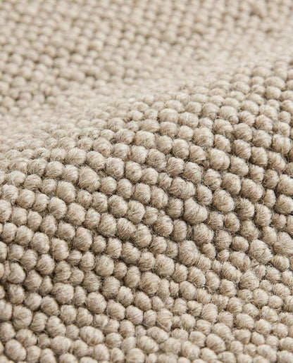 Chunky wool loop rug in neutral beige with textured, handmade cozy minimalist design