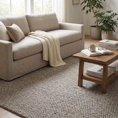 Chunky wool area rug in neutral beige with thick textured weave for cozy minimalist living room decor