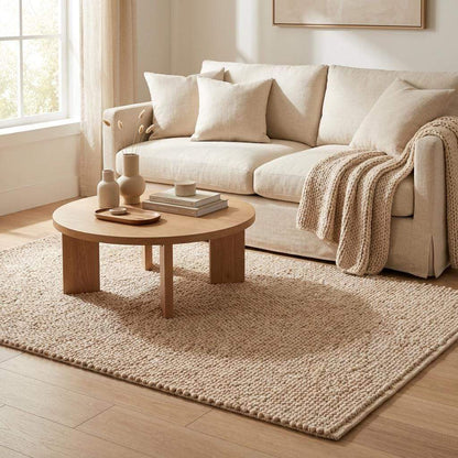 Chunky wool pebble rug in neutral beige with textured pebble weave for minimalist modern living room decor