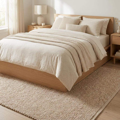 Chunky wool pebble rug in neutral beige with handwoven texture for minimalist modern living room decor
