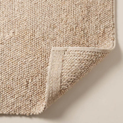Chunky wool pebble rug in neutral beige handwoven minimalist modern living room carpet decor