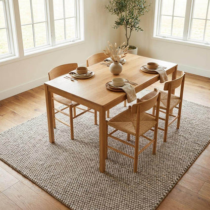 Chunky wool area rug in neutral beige with thick textured weave for cozy minimalist decor