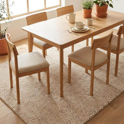 Handmade chunky wool rug with neutral beige and cream felt balls for modern farmhouse decor