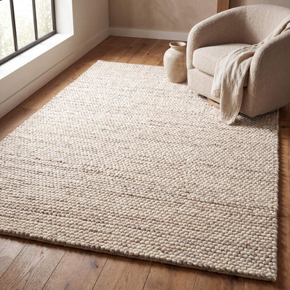 Handmade chunky wool rug in neutral beige and cream felt balls for modern farmhouse decor