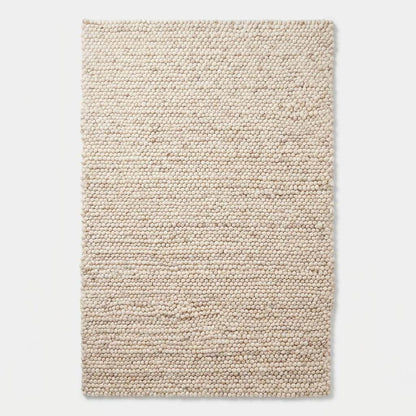 Handmade felt ball wool rug in neutral ivory with chunky texture for Scandinavian home decor
