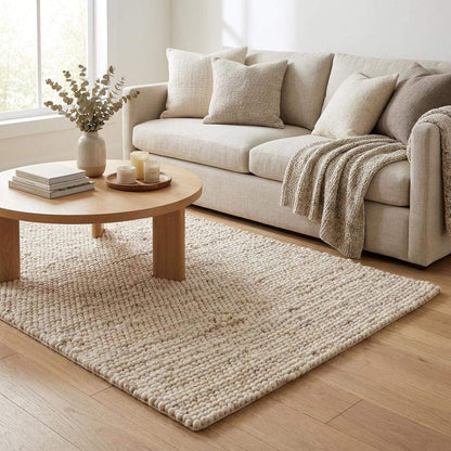 Handmade felt ball wool rug in neutral ivory with chunky texture for Scandinavian home decor