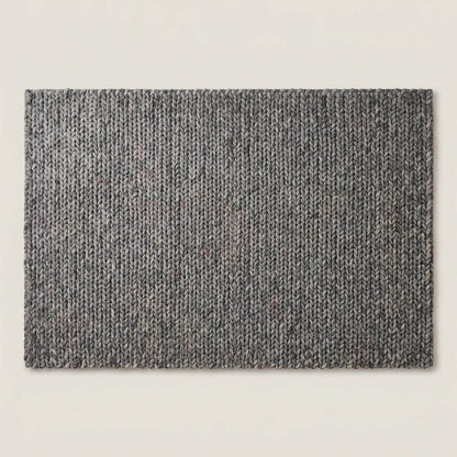 Handwoven chunky knit wool rug in gray with oversized braid design for modern Scandinavian living room decor