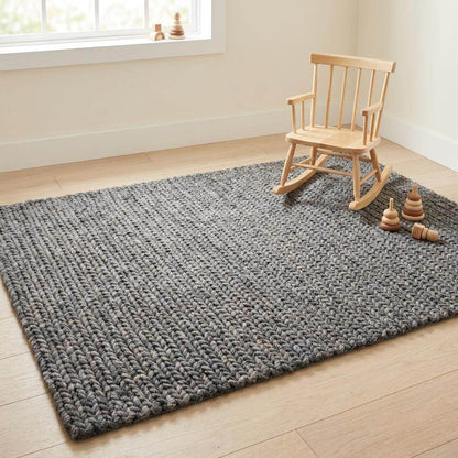 Handwoven chunky knit wool rug in gray with oversized braid design for modern Scandinavian living room decor