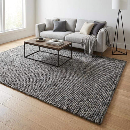 Handwoven chunky knit wool rug in gray with oversized braid design for modern Scandinavian living room decor