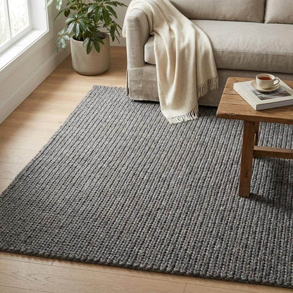 Handwoven chunky knit wool rug in gray with oversized braid design for modern Scandinavian living rooms