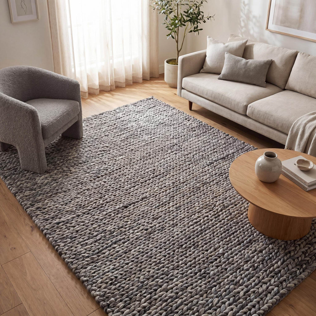 Handwoven chunky knit wool rug in gray with oversized braid pattern for modern Scandinavian living room decor
