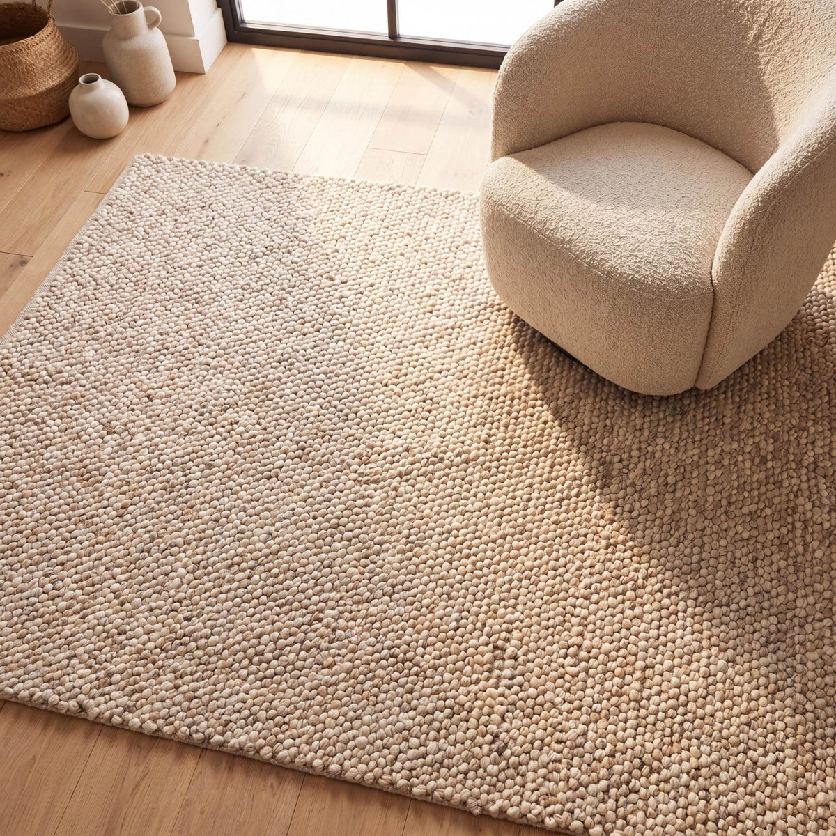 Chunky wool pebble rug in neutral beige with textured handwoven pebble design for minimalist modern living room decor