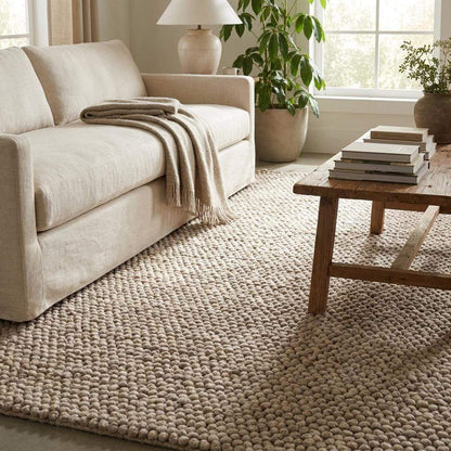 Handmade chunky wool rug with neutral pebble weave and Scandinavian Japandi design for cozy modern interiors