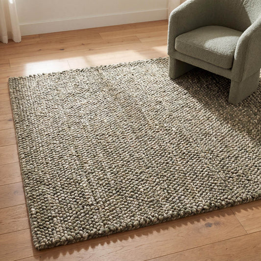 Handwoven chunky wool rug with pebble texture in neutral tones for modern Scandinavian and farmhouse interiors