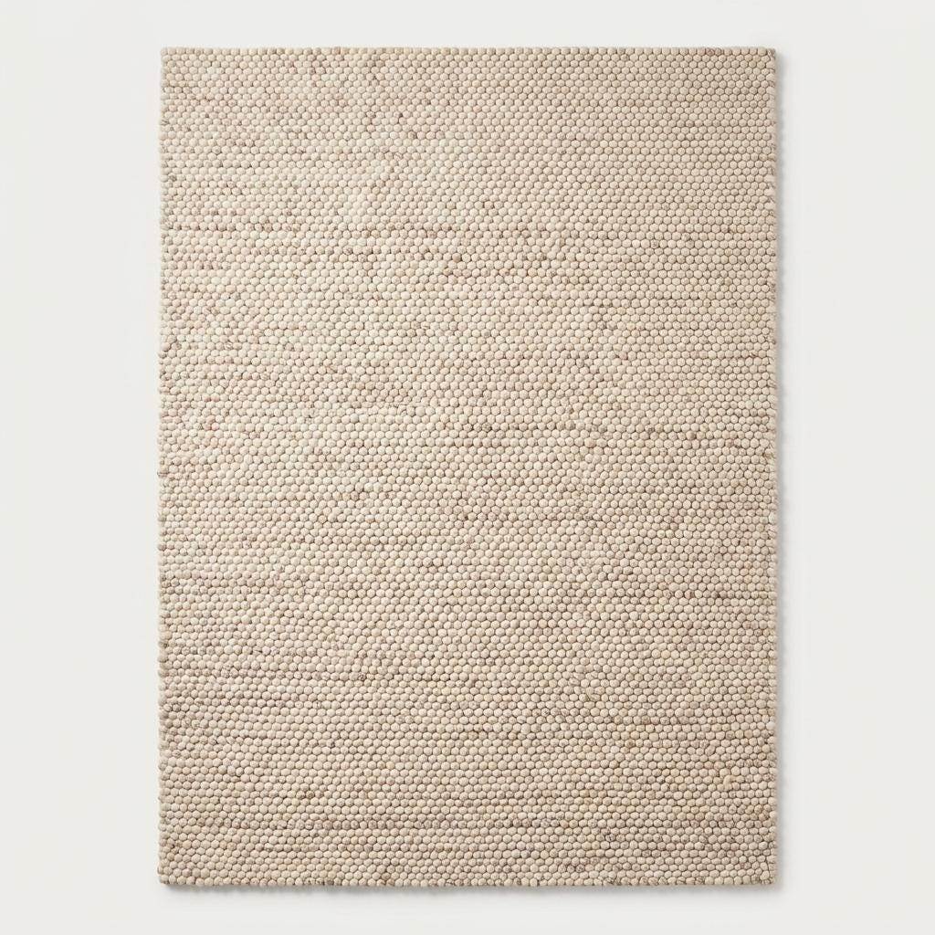 Handmade chunky wool rug with neutral beige and cream felt balls for modern farmhouse and minimalist decor