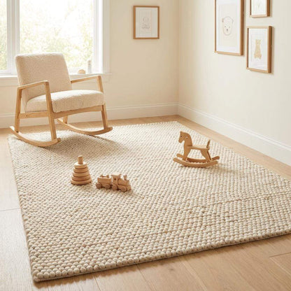Handmade felt ball wool rug in neutral ivory, chunky wool texture, Scandinavian home decor style