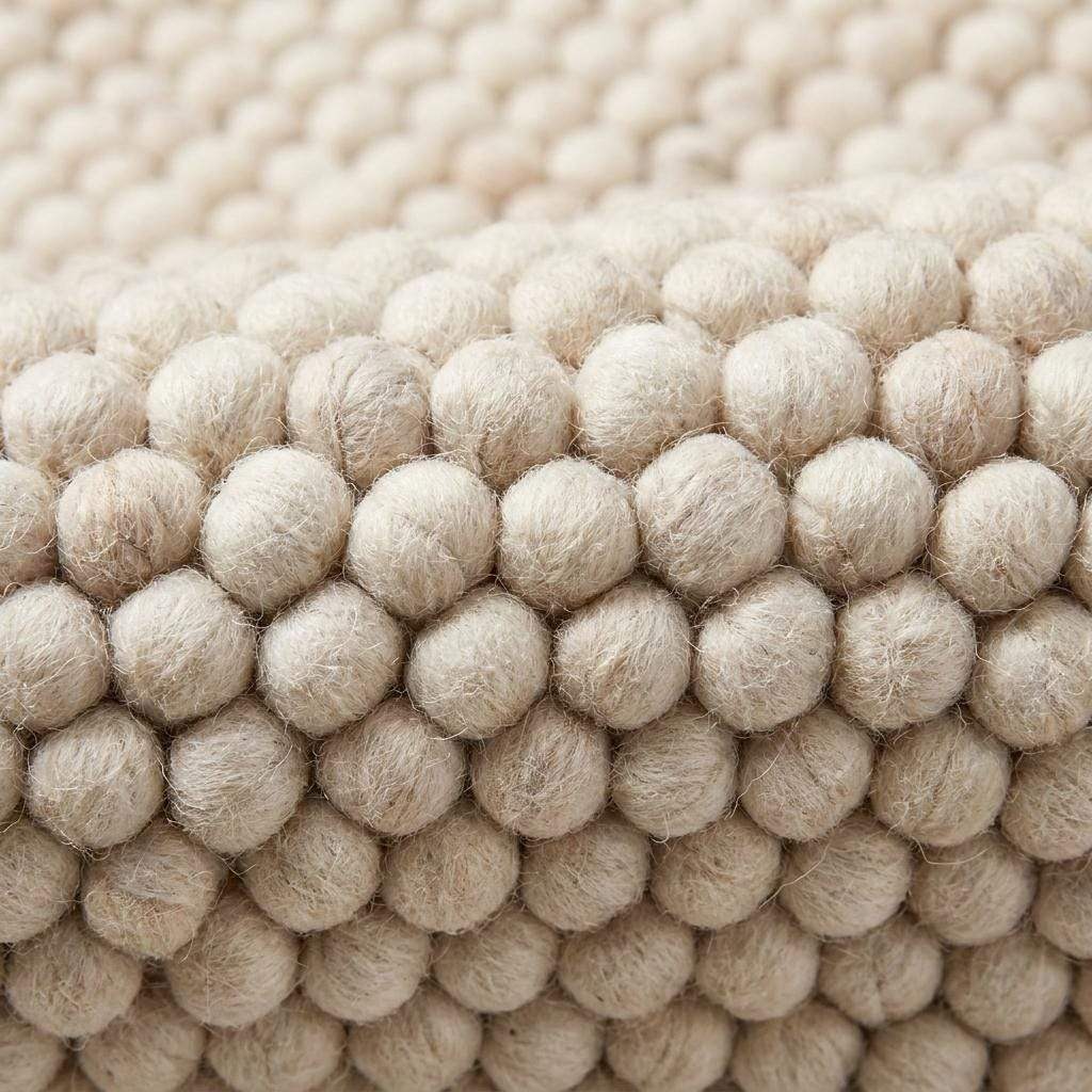 Handmade felt ball wool rug in neutral ivory with chunky texture for Scandinavian home decor