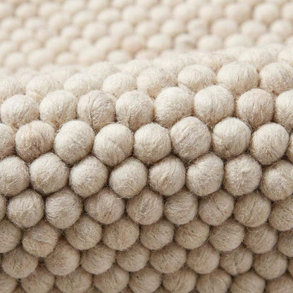 Handmade felt ball wool rug in neutral ivory with chunky texture for Scandinavian home decor