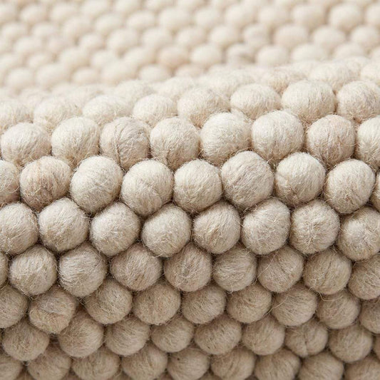 Handmade felt ball wool rug in neutral ivory with chunky texture for Scandinavian home decor