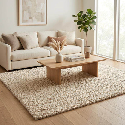 Handwoven chunky wool pebble rug in natural ivory for modern nursery and living room decor