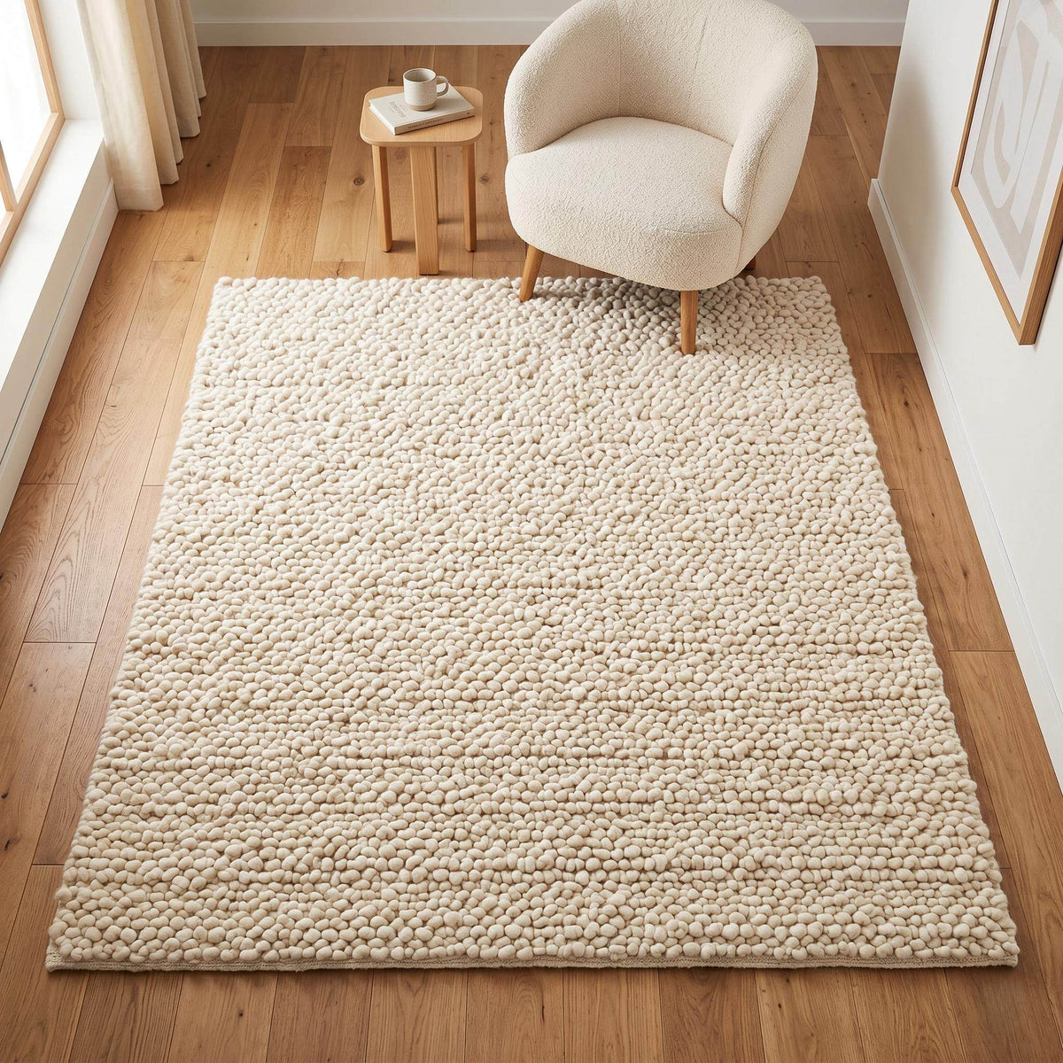 Handwoven chunky wool pebble rug in natural ivory color, luxury textured area rug for modern living room with Scandinavian home decor.