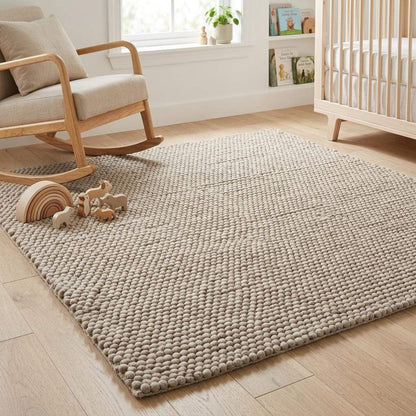 Handwoven chunky wool pebble rug in neutral beige with thick texture for Scandinavian modern decor
