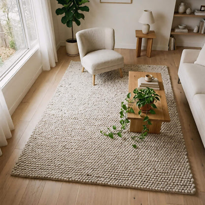 Handwoven chunky wool pebble rug in neutral beige with thick textured weave for Scandinavian modern decor