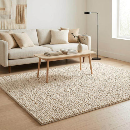 Handwoven chunky wool pebble rug in natural ivory for modern nursery and living room interiors
