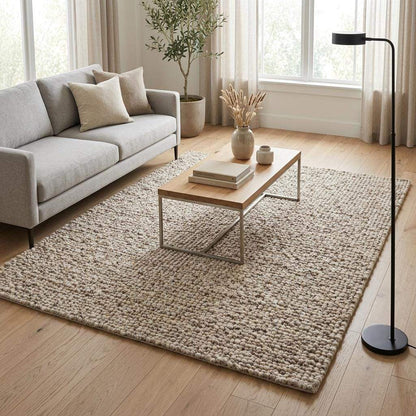 Handwoven chunky wool rug with natural beige pebble texture in Scandinavian living room setting