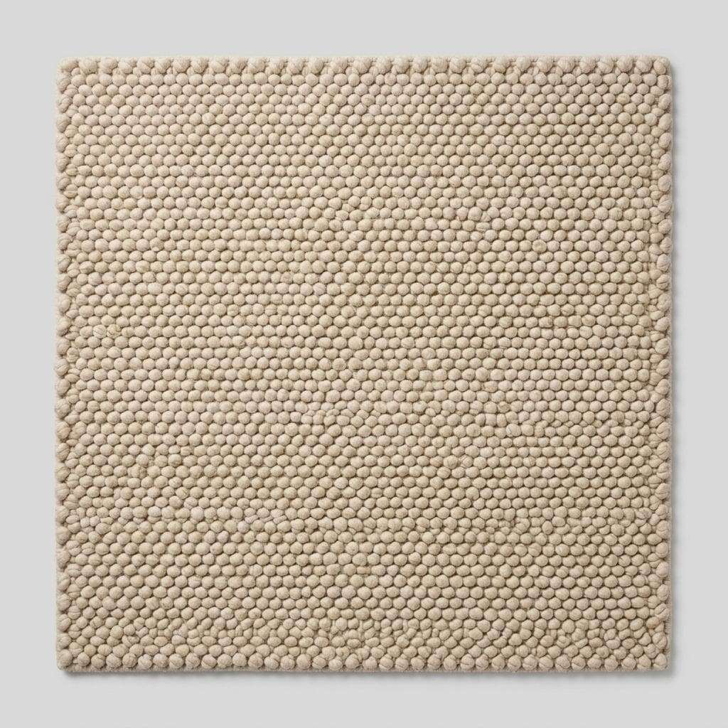 Handwoven chunky wool pebble rug in ivory with textured pebble weave for modern minimalist decor