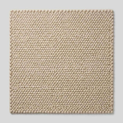 Handwoven chunky wool pebble rug in ivory with textured pebble weave for modern minimalist decor