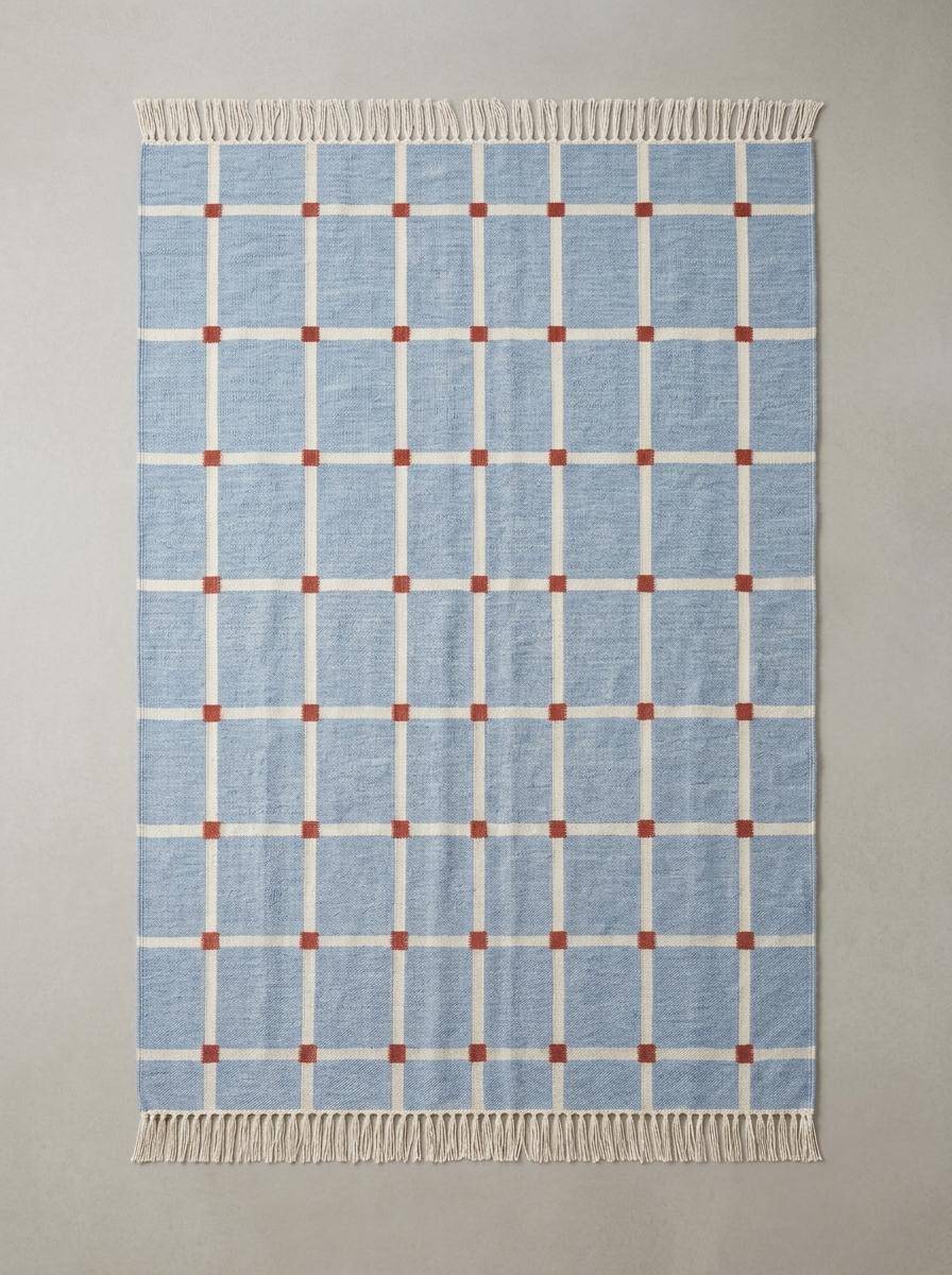 Handwoven flatweave blue grid rug with terracotta accents for modern farmhouse living room
