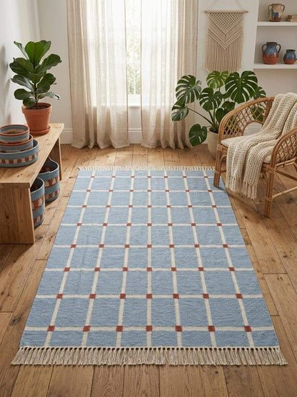 Handwoven flatweave blue grid rug with terracotta accents, modern farmhouse living room carpet