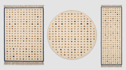 Ivory wool flatweave kilim rug with navy border and geometric motifs in living room