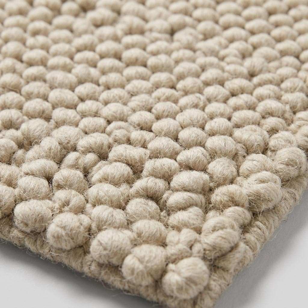 Handwoven chunky wool pebble rug in ivory with textured minimalist design for modern home decor
