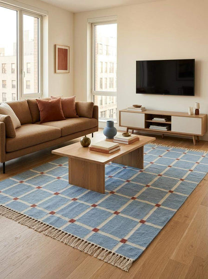 Handwoven flatweave blue grid rug with terracotta accents in modern farmhouse living room