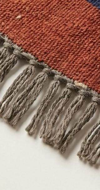 Handwoven flatweave wool rug with Southwestern cross geometric pattern in rust and navy for living room