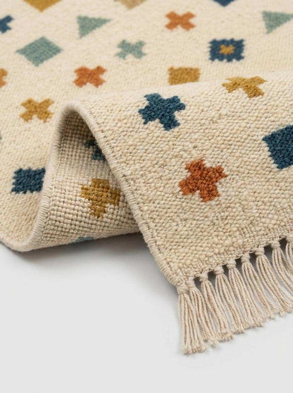 Ivory wool flatweave kilim rug with navy border and geometric motifs in living room setting