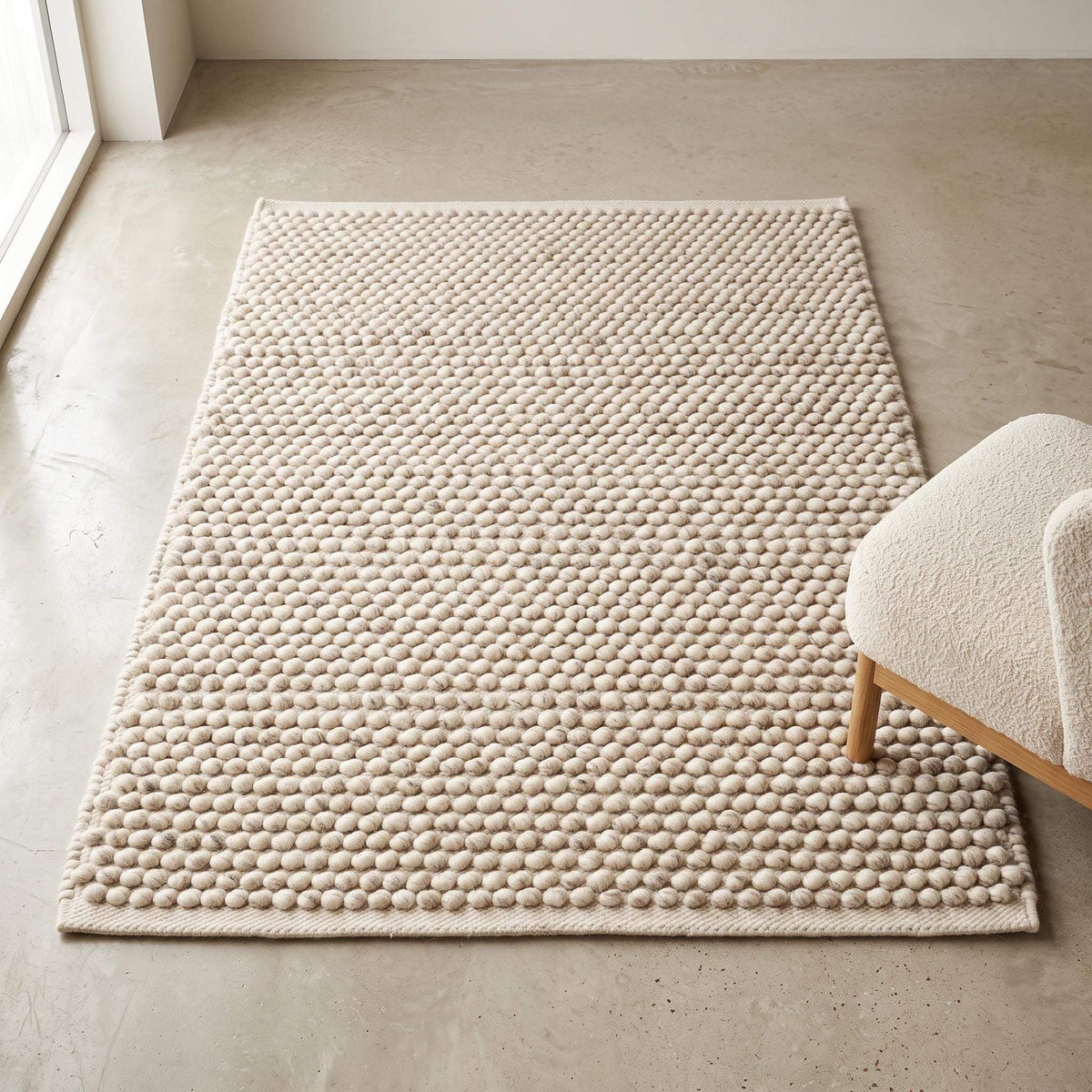 Handwoven pebble weave wool area rug in ivory beige with textured chunky loops for living room decor