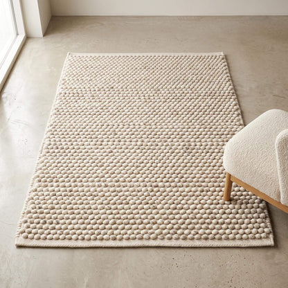 Handwoven pebble weave wool area rug in ivory beige with textured chunky loops for living room decor