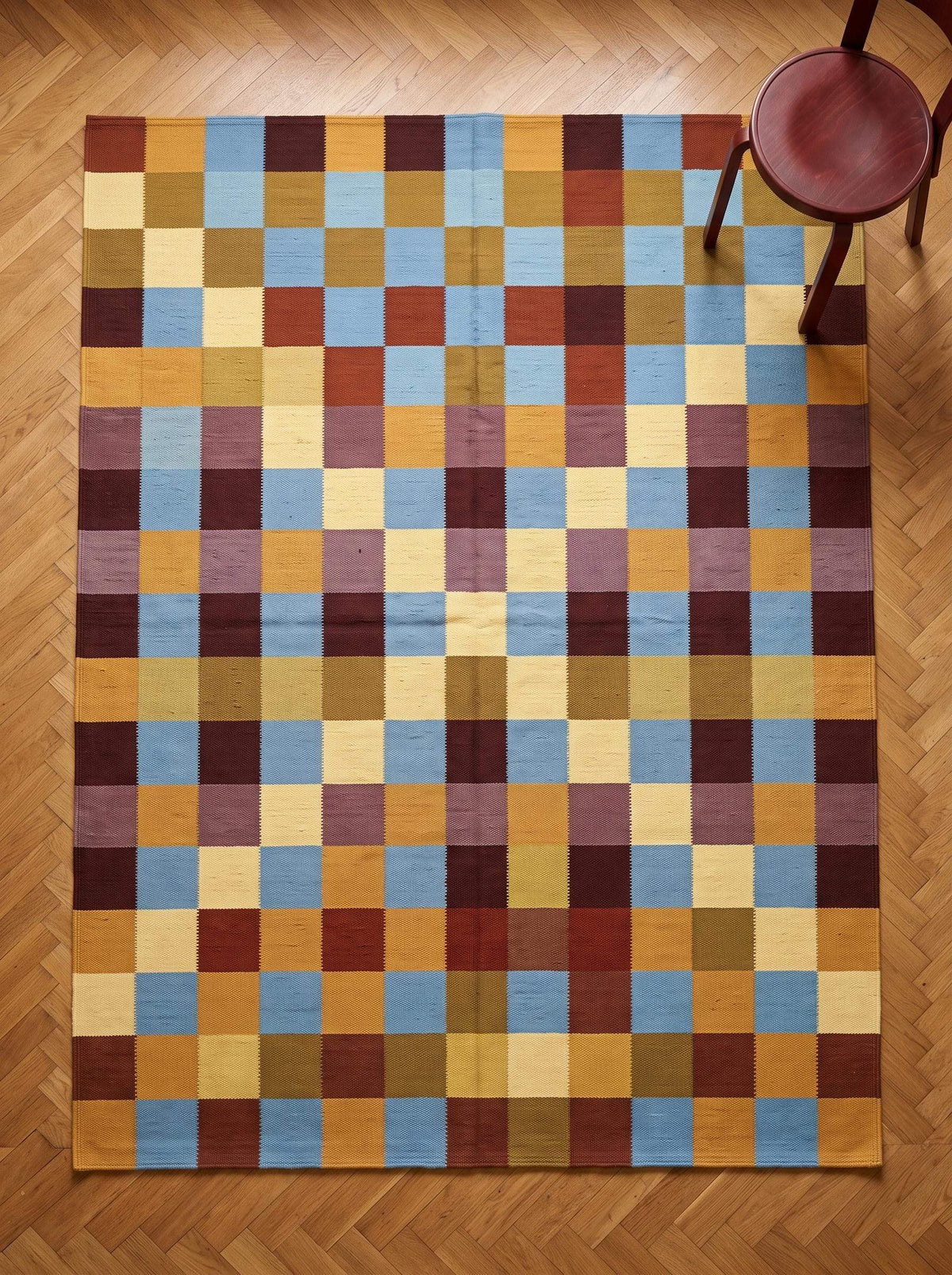 Handwoven checkerboard cotton dhurrie rug in mustard, blue, and burgundy flatweave design
