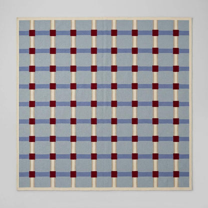 Pale blue flatweave wool rug with red grid check pattern, handwoven dhurrie for modern living room