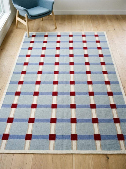 Pale blue flatweave wool rug with red grid check pattern, handwoven modern living room dhurrie