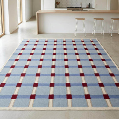 Handwoven pale blue flatweave wool rug with red grid check pattern for modern living room
